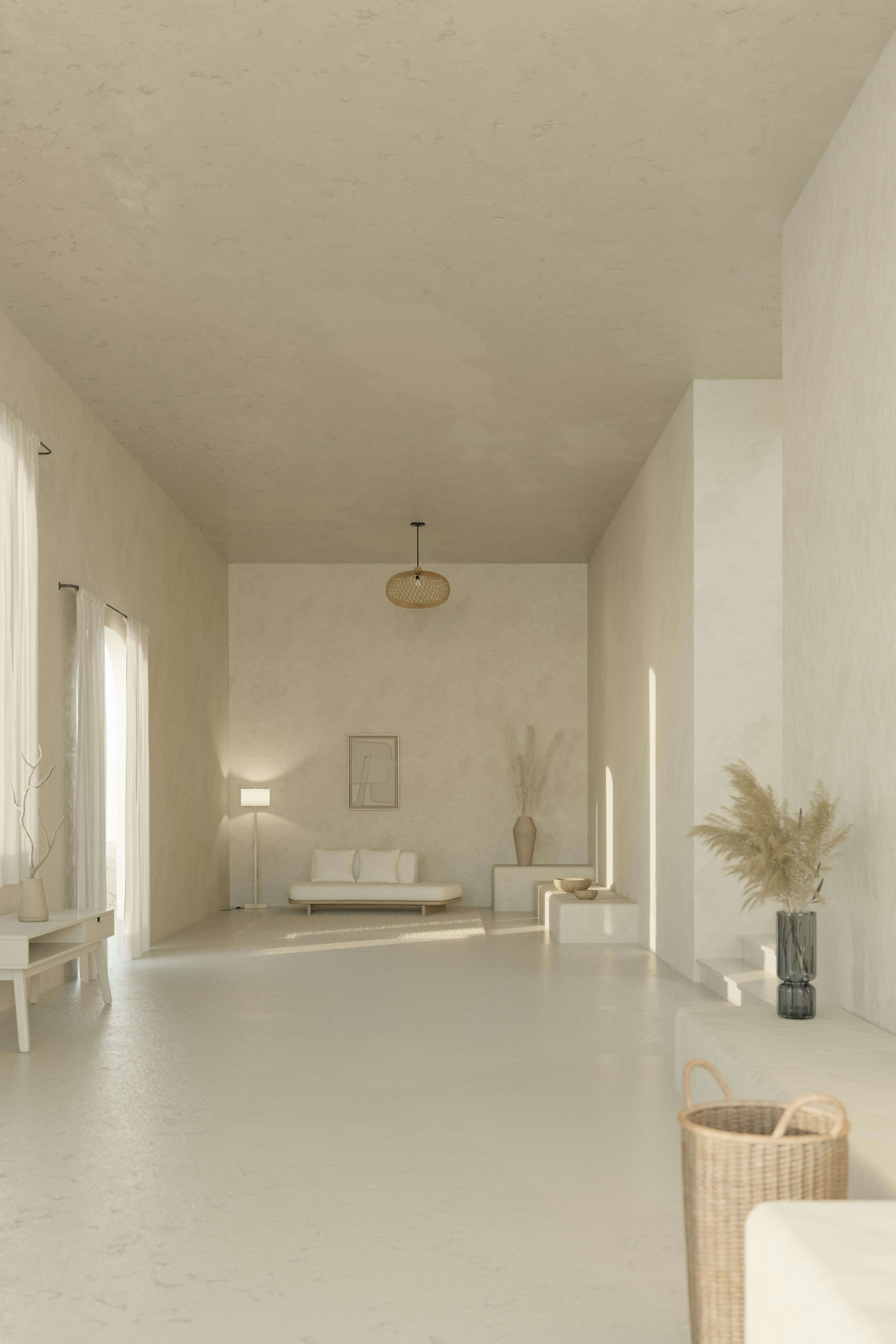 a-long-white-room-with-a-couch-and-a-table